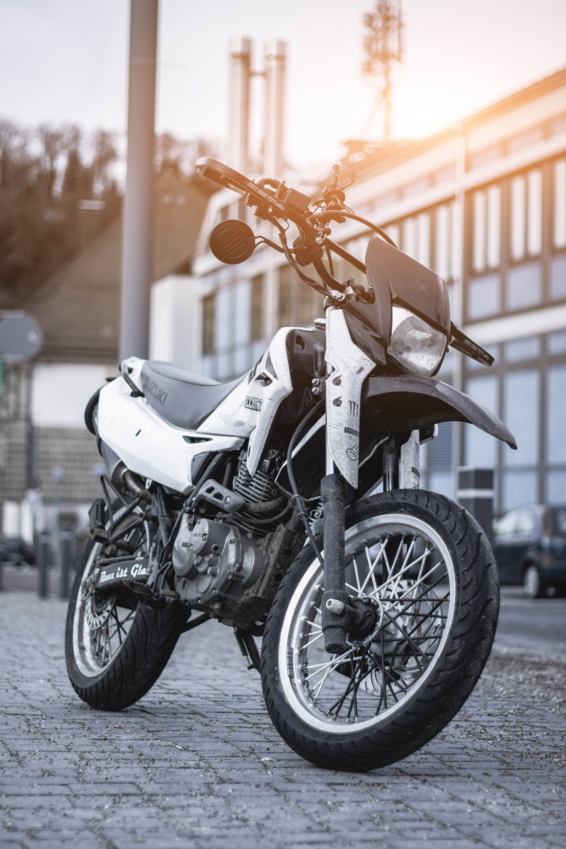 park, mode of transportation, security, machine, motocross, white, street, vehicle, parking, outdoors, bicycle, black, automobile, nature, land vehicle