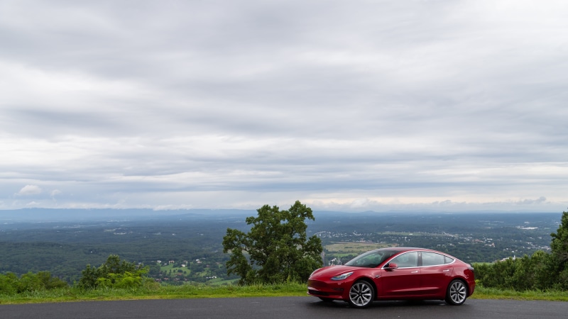 tree, trip, car wheel, road trip, travel, beauty in nature, machine, day, cloud - sky, road, mountain, alloy wheel, mode of transportation, vehicle, red