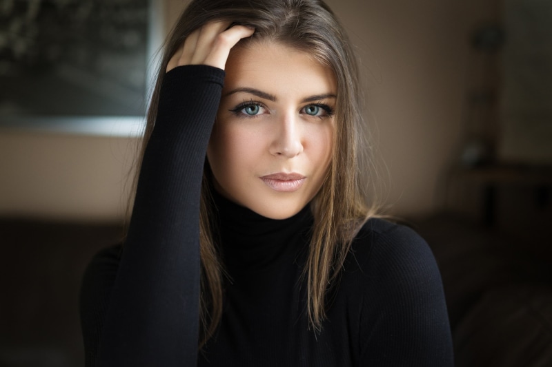young adult, indoors, bokeh, blue eyes, looking at camera, brunette, hairstyle, hands on head, young women, women, long, human face, eyeliner, headshot