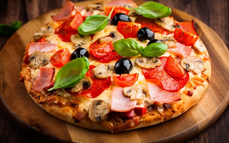 olive, pizza, basil, vegetarian food, pepperoni, table, meal, fast food restaurant, fruit, drink, food and drink, vegetable, herb, tray, fast food, food