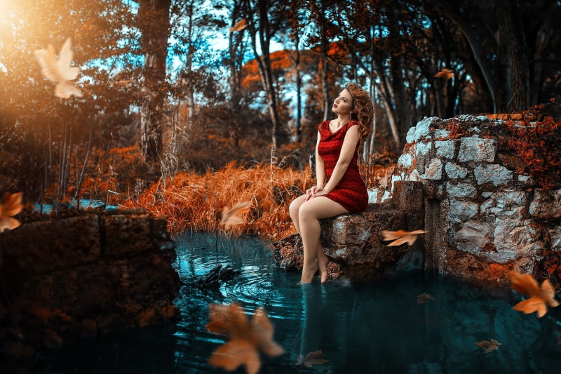 full length, sleeveless, one person, young women, fall, dress, outdoors, water, tree, forest, rock - object, Alessandro Di Cicco, plant, sitting, mini
