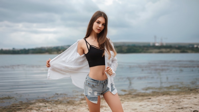 women outdoors, standing, blue eyes, sky, s, nature, young adult, three quarter length, jean shorts, water, blue, one person, day, cardigan, lifestyles