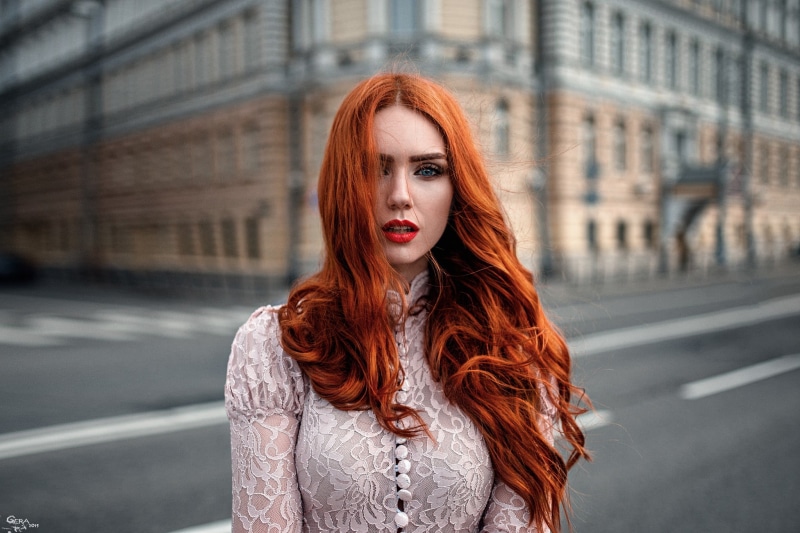 dyed red hair, fashion, city, long, women, long hair, beautiful woman, wavy hair, sleeved, adult, hairstyle, blue eyes, beautiful people, top, architecture