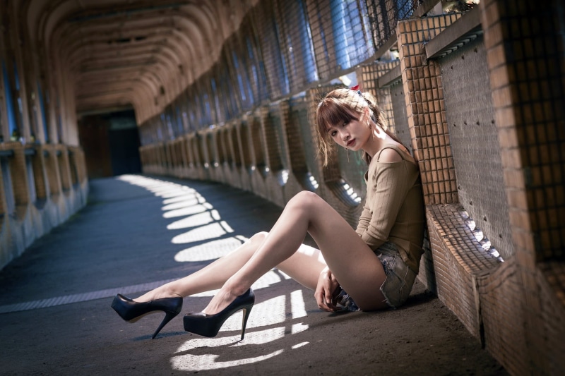 hairstyle, sitting, architecture, one person, fashion, full length, 1080P, s, shorts, high heels, side view, beautiful woman, shoe, blue, denim, clothing