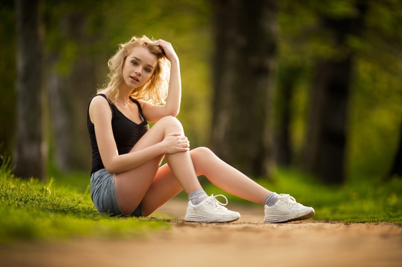plant, sneakers, beauty, women outdoors, young adult, black, shoe, blonde, socks, 1080P, tree, blue, top, long hair, beautiful woman, shorts, day, full length