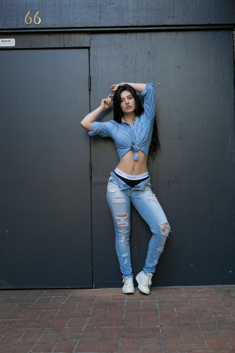young women, Calvin Klein, looking at camera, 1080P, fashion, front view, torn jeans, lifestyles, leisure activity, beautiful woman, standing, women, leaning