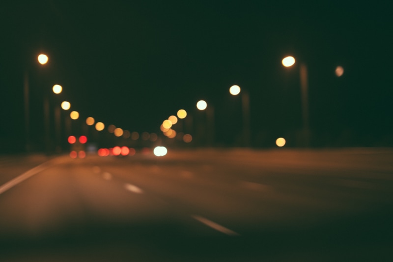 nighttime, outdoors, road, motor vehicle, dark, blurry, car, light, mode of transportation, evening, light - natural phenomenon, lens flare, vehicle light