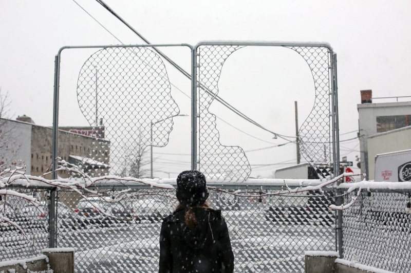 model, two, outdoors, built structure, fences, street, building exterior, city, coats, street art, barrier, winter, safety, branch, fence, black jackets