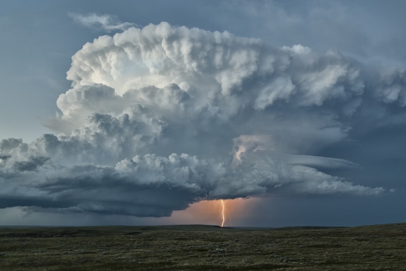 outdoors, storm, land, power, field, warning sign, non-urban scene, remote, day, plains, nature, clouds, environment, no people, landscape, sky, lightning