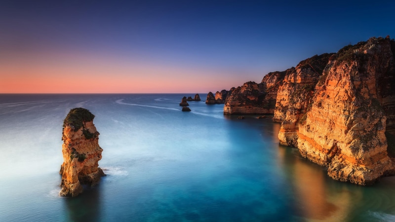 cliff, sky, rocky, idyllic, beauty in nature, rock, tranquil scene, horizon, water, beach, sunset, rock formation, land, rock - object, lagos, nature, tranquility