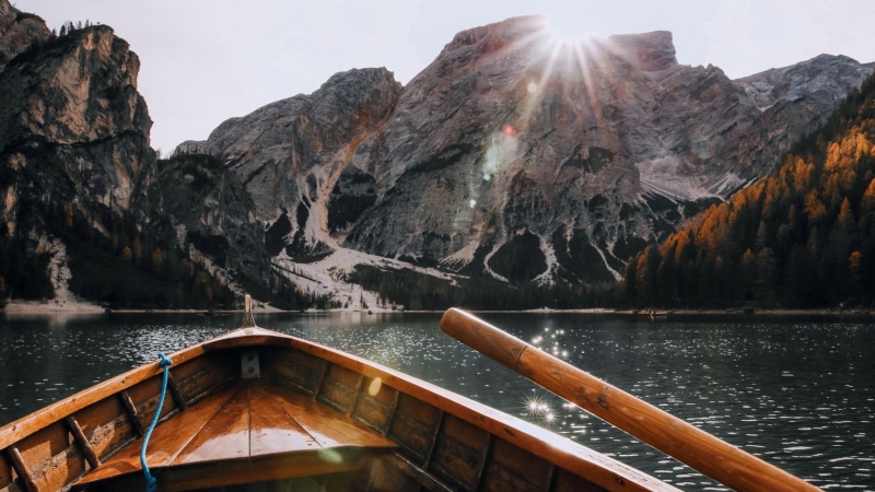 sunbeam, transportation, boat, mountain, no people, sky, rowing boat, rock, mountain range, tourism, pragser wildsee, italy, dolomites, sun ray, cliff