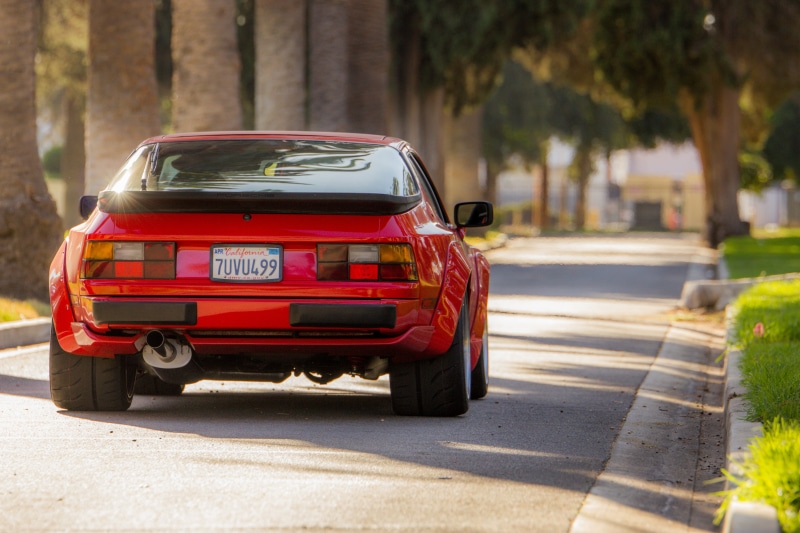 Porsche, mode of transportation, day, plant, travel, motor vehicle, porsche 944, red, transportation, street, shadow, race cars, tree, land vehicle, widebody