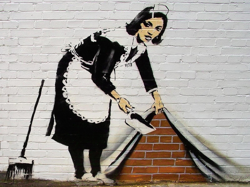 wall - building feature, one Person, banksy, building exterior, wall, maid, people, arts culture and entertainment, day, brick wall, string instrument