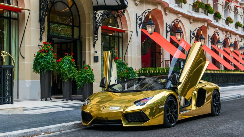 no people, yellow, transportation, gold, lamborghini, outdoors, motor vehicle, vehicle, flag, architecture, building, street, stationary, golden, car, parking