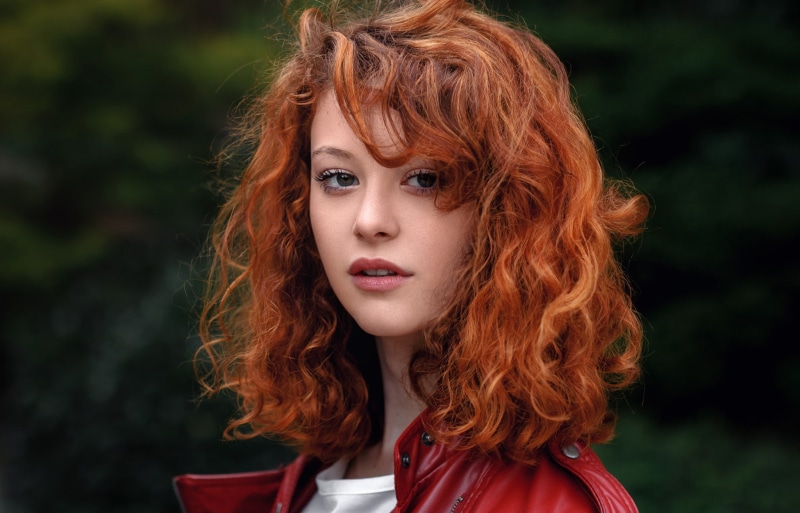 long hair, hair, redhead, beauty, outdoors, curly hair, one person, hairstyle, leather jackets, front view, portrait, face, young adult, adult, looking at viewer