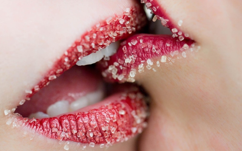 human lips, human teeth, human face, extreme close-up, beauty product, red lipstick, sugar, young adult, body part, close-up, studio shot, human mouth