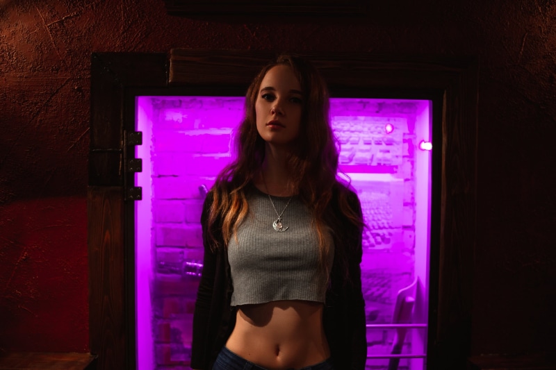 2K, grey tops, jeans, pink, crop top, neon lights, long hair, necklace, belly, model, dark, Ksana Stankevich, portrait, brunette, women, indoors, women