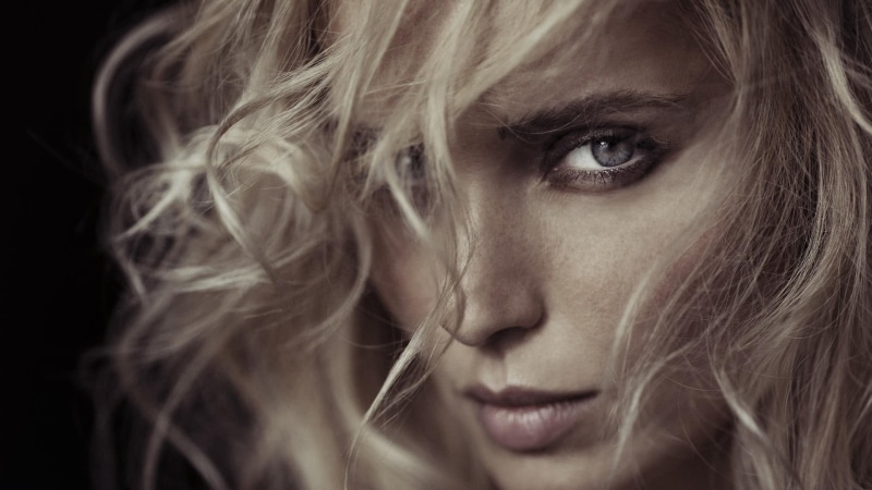 face, contemplation, human face, one person, young adult, teenager, hairstyle, hair in face, emotion, black background, portrait, aggression, hair, blonde