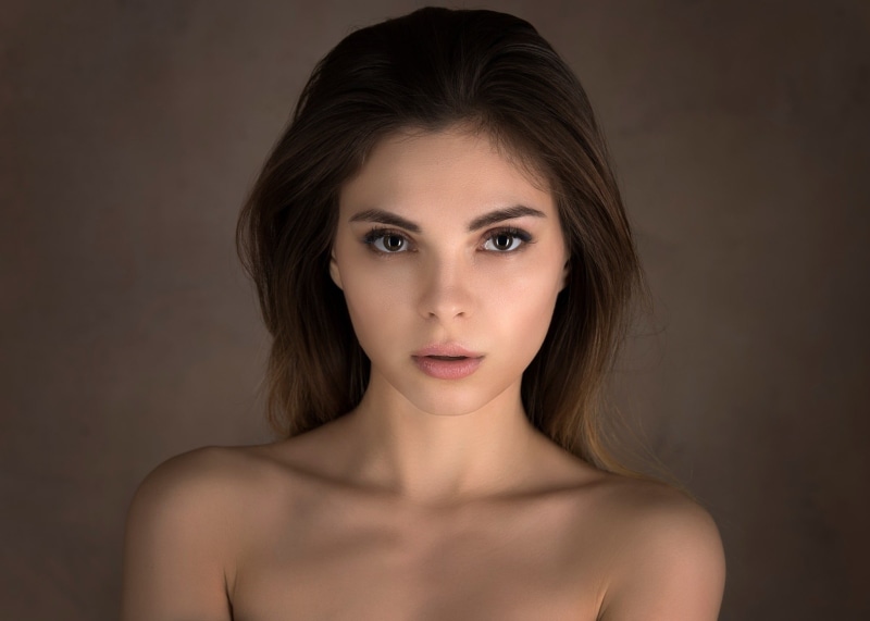long hair, front view, young adult, headshot, eyeliner, bare shoulders, young women, brunette, open mouth, adult, face, one person, indoors, 1080P, fashion