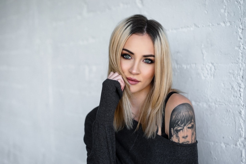 human hair, standing, headshot, one person, warm clothing, portrait, young adult, front view, women, bare shoulders, tattoo, hair, cold, young women, blonde