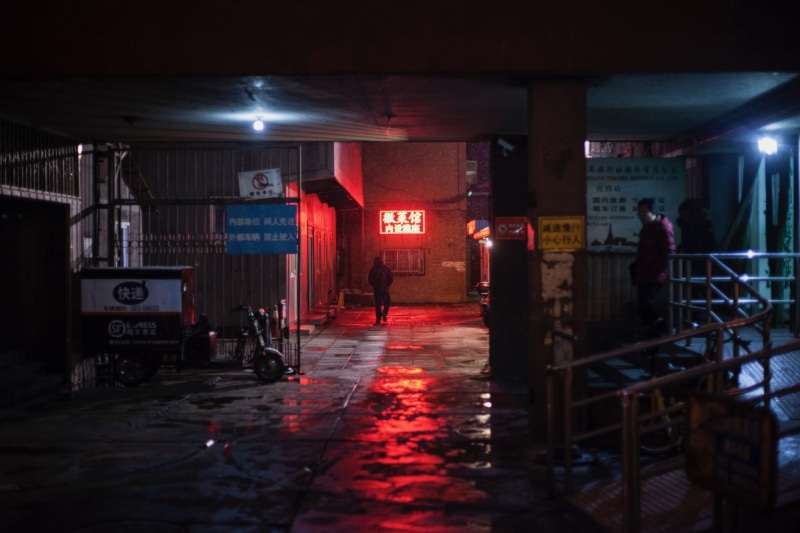 neon, western script, toward, walking, city, lighting equipment, architecture, night time, communication, text, indoors, sign, incidental people, person
