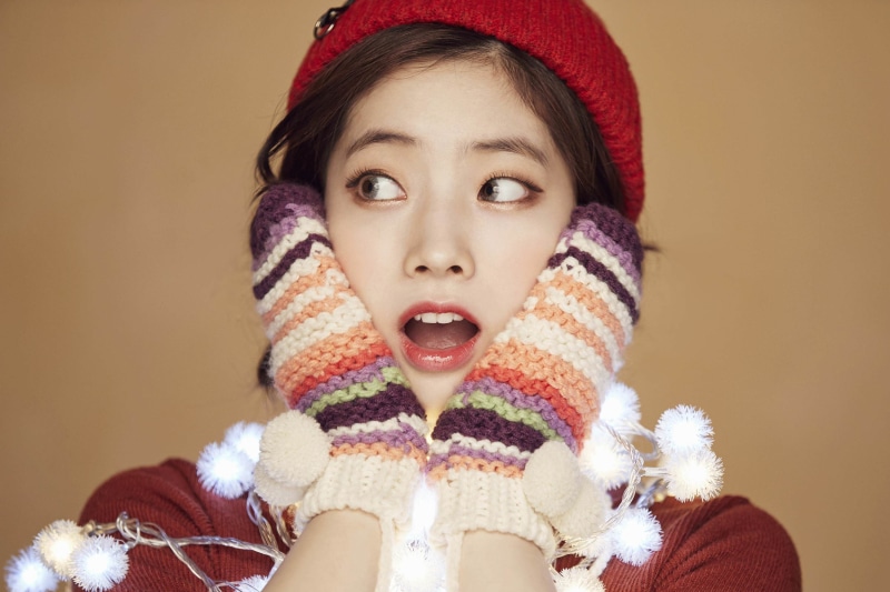 singer, looking at camera, warm clothing, sweater, knit hat, hat, K-pop, winter, studio shot, colored background, innocence, 2K, women, body part, wool