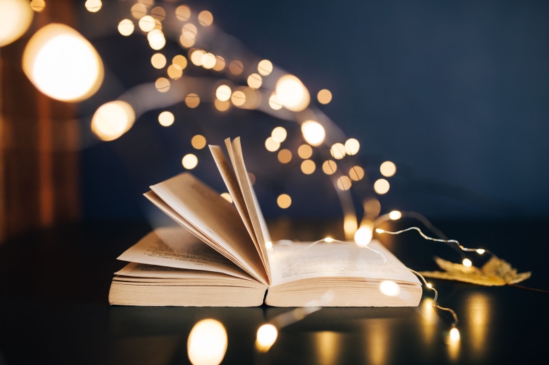 hardcover book, publication, open, Fairy Lights, indoors, lighting equipment, table, lights, defocused, elegance, night, literature, activity, paper, making