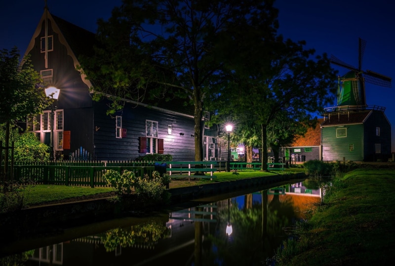 architecture, body, trees, wooden, night, fence, outdoors, Netherlands, water, house, windmill, no people, blue, reflection, building, lights, built structure