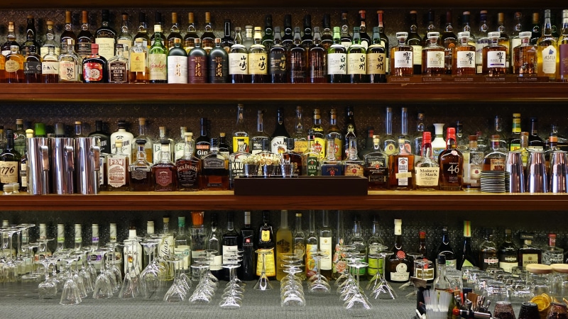 glass, in a row, liquor store, bottles, party, abundance, hard liquor, no people, pub, collection, nightlife, alcoholic, bar, arrangement, wooden, wine glasses