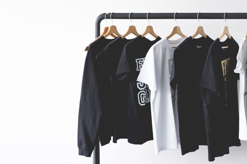 no People, white wall, fashion, collection, in a row, cotton, black color, closet, retail, indoors, room for text, tees, selling, elegance, choice, clothes rack