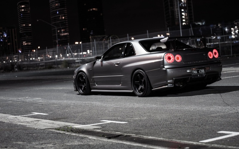 symbol, gray, Tuner Car, JDM, tuning, Skyline R34, illuminated, Nissan, land vehicle, street, night, city street, road, built structure, on the move, mode of transportation