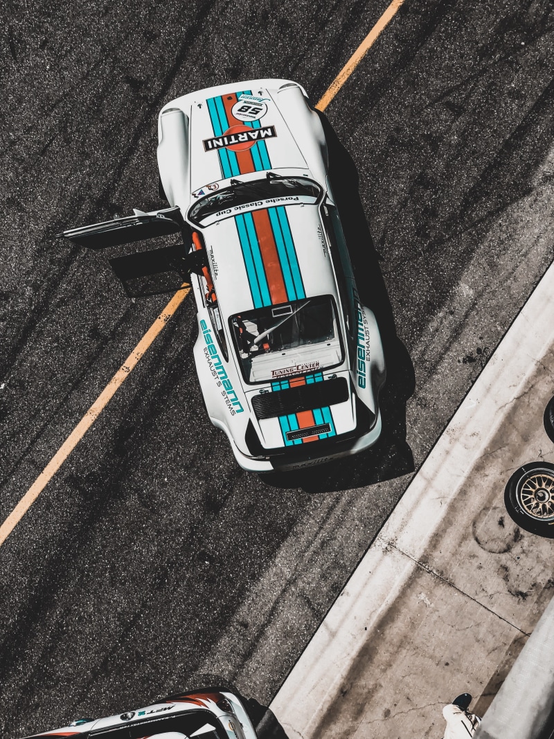 cars, automobile, travel, sign, sports, road, supercars, communication, martini racing, high angle view, porsche 911, city, daytime, mode of transportation