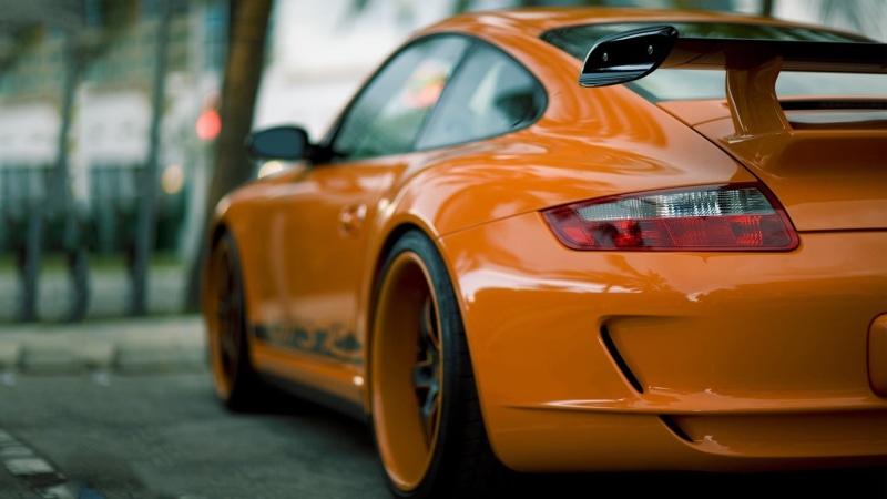no people, orange cars, public transportation, transportation, motor vehicle, street, architecture, personal land vehicle, stationary, yellow, Porsche 911