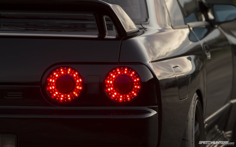 guidance, motor vehicle, night, no people, mode of transportation, tail light, city, communication, lighting equipment, car, sign, road, red, Nissan Skyline R32