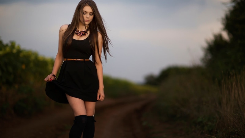 standing, brunette, fashion, straight hair, young adult, hairstyle, one person, outdoors, young women, adult, beauty, lifestyles, black dress, casual clothing