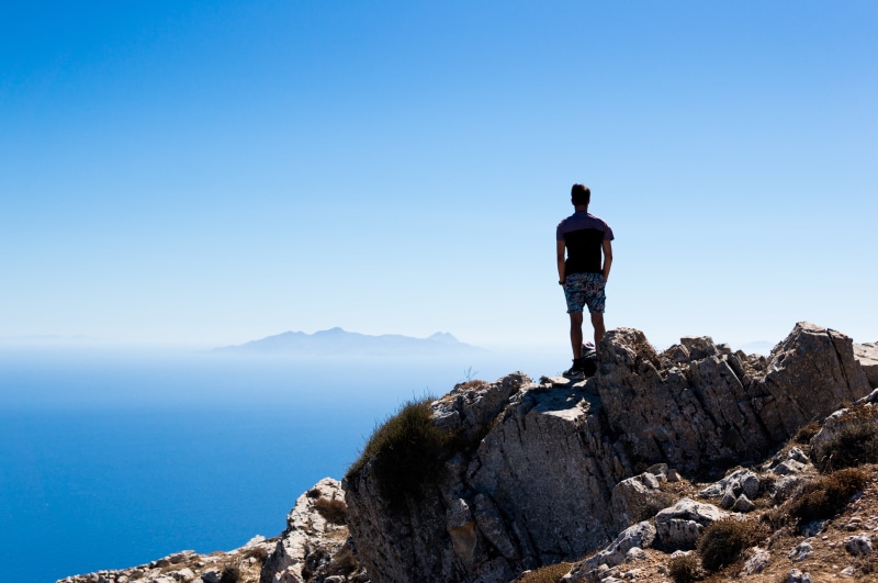 looking at view, full length, man, mountain, solitude, peak, rock, near, lifestyles, straight, cloud, sky, ocean, men, cliff, beauty in nature, water, solid