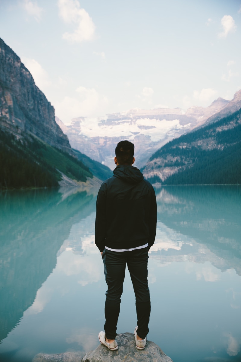 hills, leisure activity, hoodie, adult, outdoors, rear view, standing, full length, one man only, valleys, reflection, facing, tranquil scene, tranquility