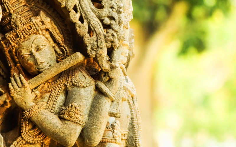 outdoors, flute, day, deity, statue, 4K, male likeness, creativity, God, spirituality, representation, Lord Krishna, carving - craft product, sculpture