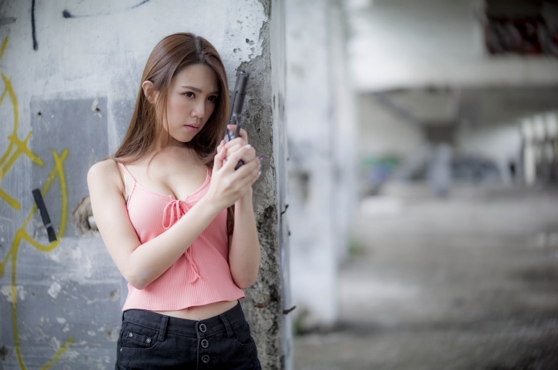 front view, portrait, three quarter length, casual clothing, holding, young adult, girls with guns, one person, looking, Asian, beautiful woman, camisole