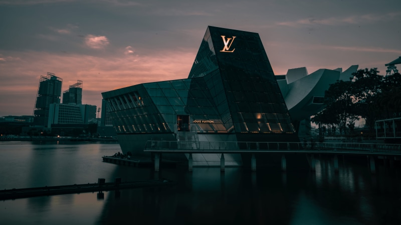 convention center, reflection, pier, city, waterfront, architecture, office building, vehicle, outdoors, dusk, sunlight, skyscraper, building, dock, transportation