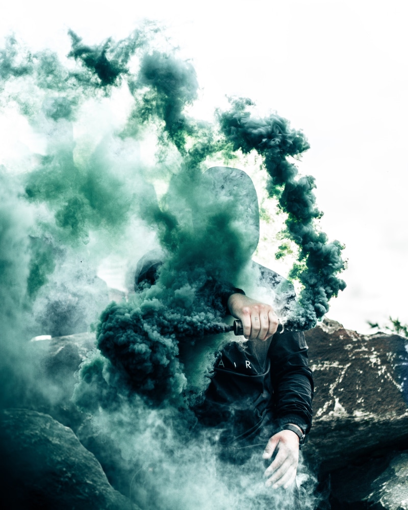 rock, cover, bottle, warning sign, communication, grenade, lifestyles, anonymou, power in nature, one person, bomb, green, outdoors, real people, activity