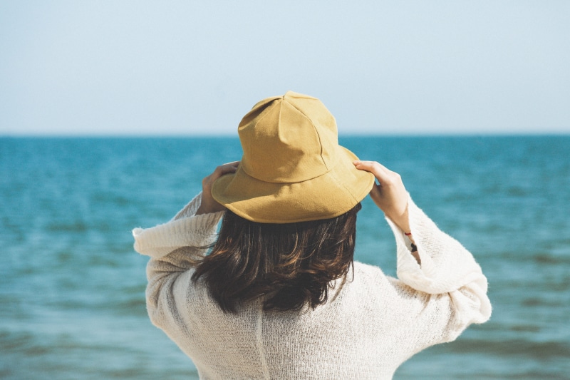 looking away, carefree, long Hair, outdoors, caucasian Ethnicity, day, beauty In Nature, open sea, beach, vacations, sunny, shoreline, one Person, windy