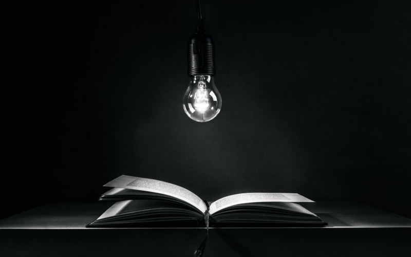 table, learning, studio shot, book, studying, black, no people, lighting equipment, light, electricity, education, paper, copy space, textbook, page, dark