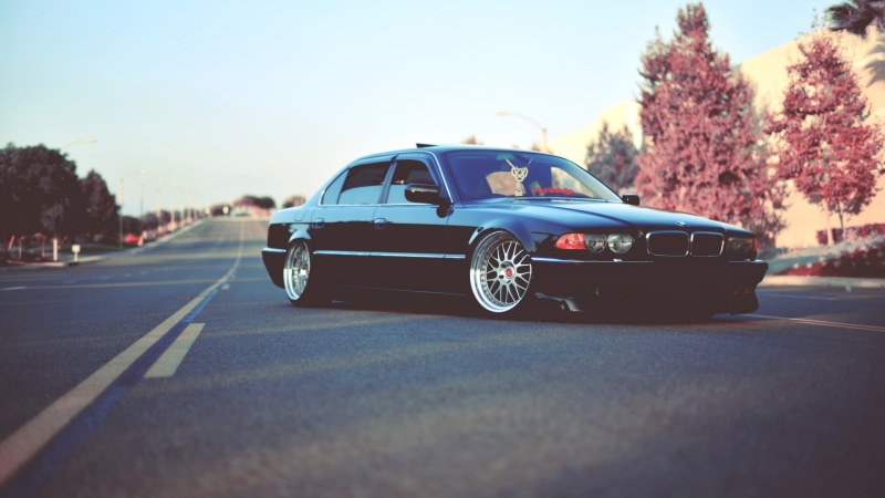 city, land vehicle, road, black, sky, selective focus, mode of transportation, motor vehicle, outdoors, car, 1080P, street, symbol, blue, plant, bmw E38