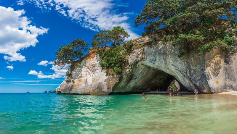 beauty in nature, water, leisure activity, island, travel, surf, beach, tourism, trip, sea, rock formation, coastline, coast, natural, cathedral cove, tranquility