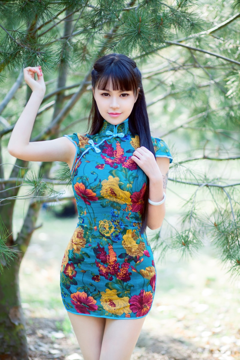 beautiful woman, plant, tree, 5K, dress, pink, floral, three quarter length, smiling, hairstyle, brunette, mini, hair, positive emotion, blue, happiness