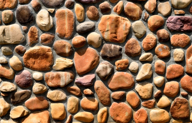 large group of objects, stone, architecture, texture, background, wall, brown, day, building, cement, brick, exterior, abundance, pebble, concrete, high angle view