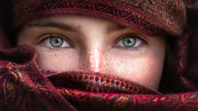 human body part, blue eyes, clothing, eye, model, close-up, hat, looking at camera, young adult, winter, red, eyes, one person, adult, portrait, headshot