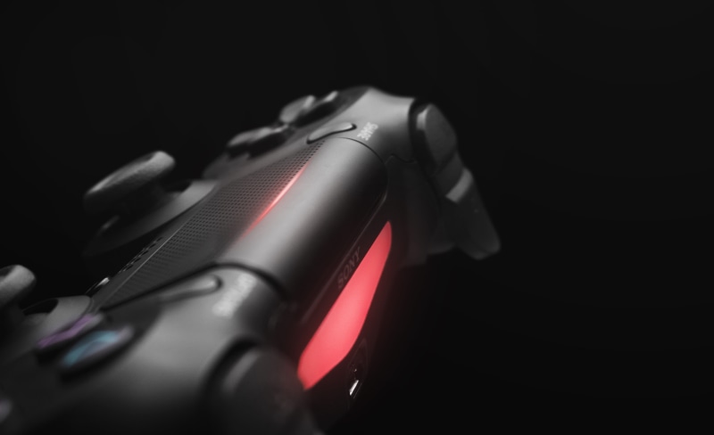 indoors, dark, photography, black color, gun, playstation 4, no people, close, single object, weapon, dualshock, sony, selective focus, controller, red