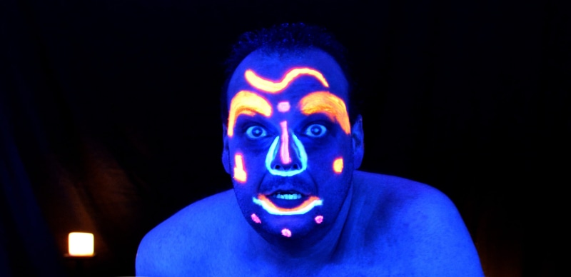 body paint, adult, looking at camera, face paint, surprise, uv inks, anger, shock, indians, black background, people, fear, mouth open, black light, reflection